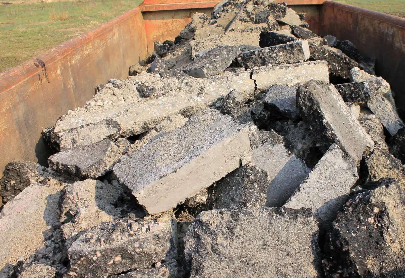 Dump body loaded with broken concrete and asphalt hauled off a demolition site